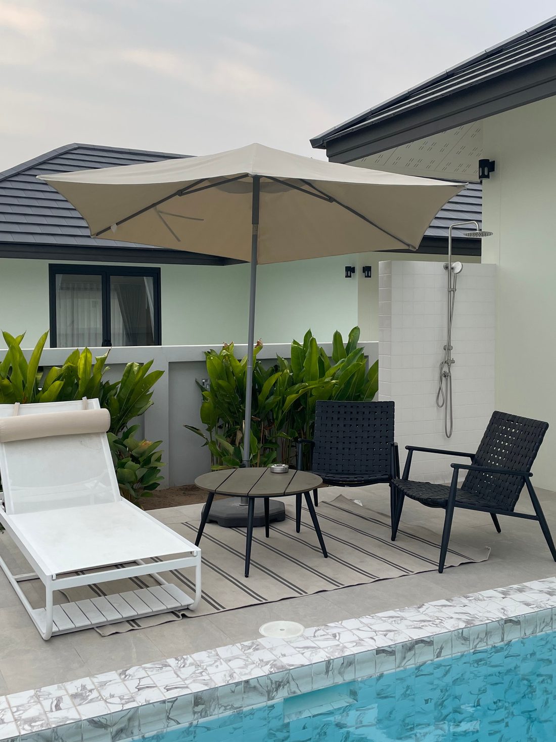 Poolside area with umbrella